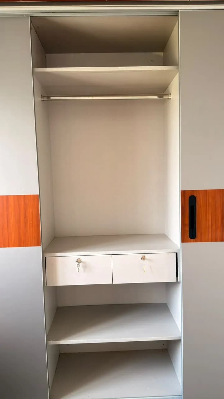 A finished Aakar Modular wardrobe run with a black-glass open unit and mirror panel
